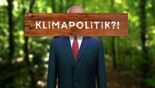 Politiker mit Brett vor dem Kopf: "Klimapolitik?!"