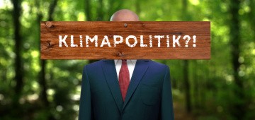 Politiker mit Brett vor dem Kopf: "Klimapolitik?!"