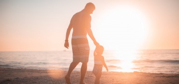 Vater und Kind in der Sonne am Meer
